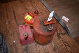 2 metal gas cans, 1 plastic gas can, located building 5