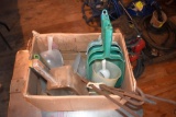 Assortment of feed and measuring scoops, located building 5