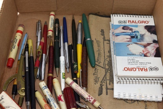 Assortment of bullet, mechanical pencils, pens, advertising booklets