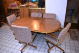 Dinning Table with 2 leaves and 6 swivel rolling padded chairs