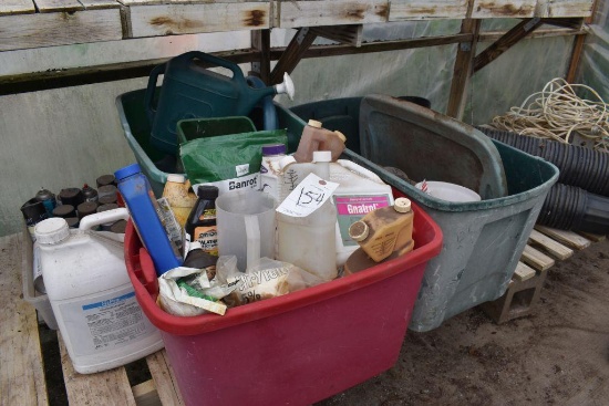 Totes containing Scotts hand seeder, watering cans, scoops, plant management products,
