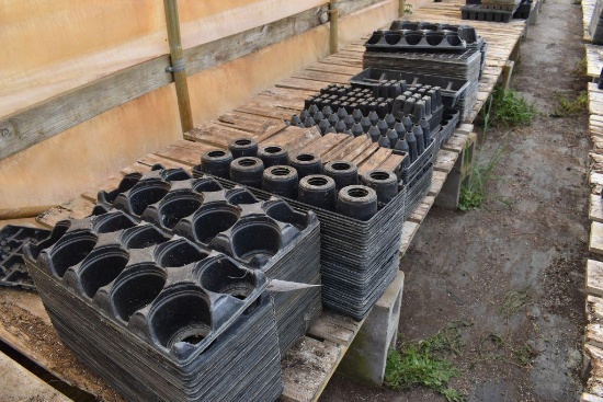 Assortment of plastic plant trays , located in GH 24