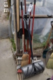 assortment of brooms and dust pans, located in Building 94