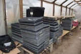 Large assortment of planter trays and plug trays , located in Building 94