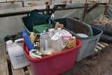 Totes containing Scotts hand seeder, watering cans, scoops, plant management products,