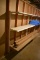 Wall Shelving on left side of room next to piping