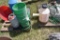 Assortment of chicken waters, garden hose, and chicken fence