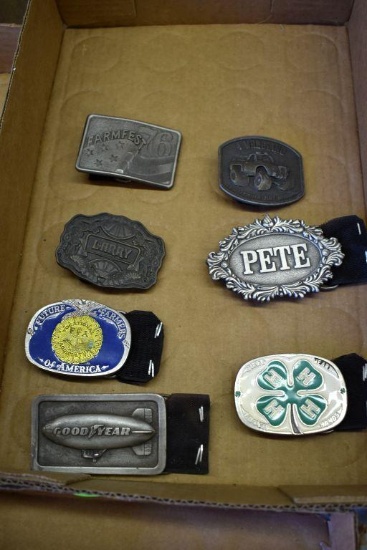 Seven belt buckles: Good Year, FFA, Larry, 1976 Farm Fest, Four wheeling, Pete, 4H