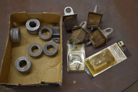 Box of assorted hydraulic stops, with rubber repair kit, truck box tie down loops, and two