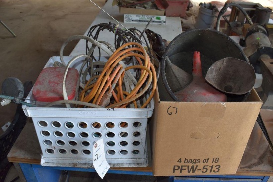 assortment of grease guns and electrical cords