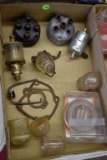Assortment of fuel bowls, brass oiler, and International steering wheel cap, all been used
