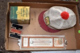 International Emblem, John Deere powdered graphite tin, M.F.E Thermometer, and Funks hat