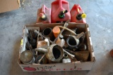 Box of automotive oil cans and 3 gas cans