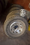 (4) 265x75x16 Goodyear Wrangler Tires on 8 Bolt Rims with (3) Center Caps