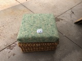 Wicker ottoman with green cushion