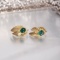 114k Gold & Emerald ClipBack earings; Leaf Motif; Set with one roundish Emerald Cabochon Ea