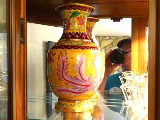 Items on top shelf of curio cabinet: Includes lighted vase, glass cross, Oriental vase and more.