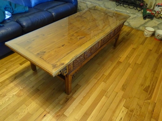 Coffee table-all wood w/ ornate side carving, glass top. 68"L x 27"W x 20" H