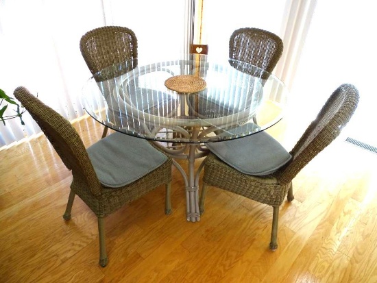 Round glass top table w/4 chairs-48" D, sturdy plastic wicker for chairs.