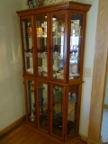 Wood frame lighted curio cabinet. 76