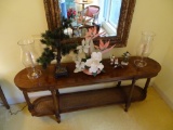 All items on table: floral arrangement, hurricane lamps, artificial tree, birds.