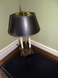 Desk lamp with candles and brass base.