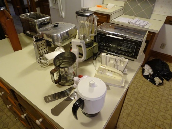 All items on counter: Electric frying pan, blender, electric can opener, grater, toaster oven, plus