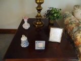 Items on table-bell, vase, picture frames, greenery