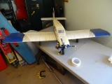 Model airplane w/4 stroke engine-remote control-made of balsa wood, gas powered.