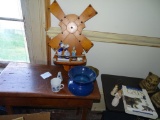 Wooden windmill wall hanging and statues, blue pottery piece and cup.