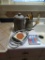Items on sink-Canister and Pitcher w/utensils, wire basket and bread warmer, misc spreaders.
