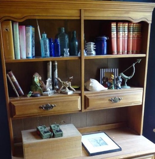 Items on shelves on top of bookcase. Walkie Talkies, Ansel Adams "Oak Tree" reproduction, bookends,