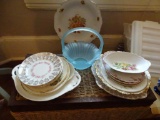 Blue glass basket and assorted china on top of chest