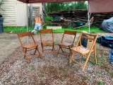 Four vintage wooden folding chairs; three match, the fourth is similar but not identical