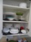 All items in cabinet; plates, bowls, platter, baking dish, juicer