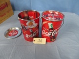 2 METAL COCA COLA CONTAINERS FILLED WITH COCA COLA ITEMS