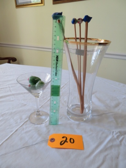 tall glass canister w/ drink stirrers, martini glass w/ olives