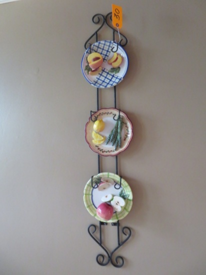 3 decorative plates in plate rack
