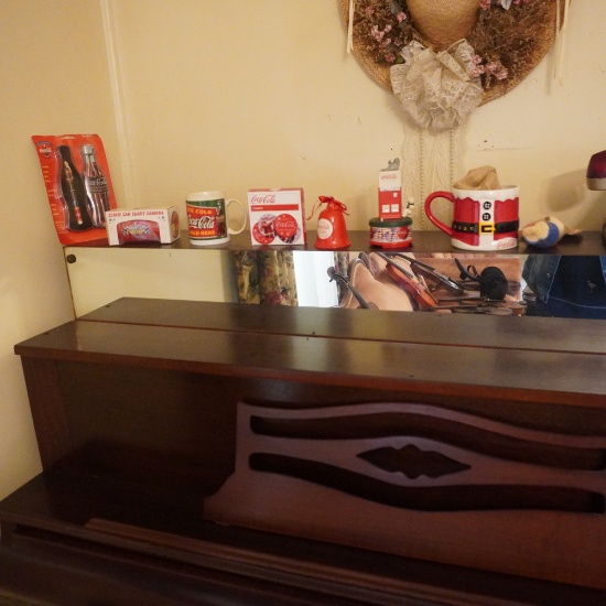 ALL COKE ITEMS ON TOP OF PIANO