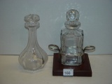 Decanter lot with wood and brass base. Etched decanter is chipped. Tallest 9”