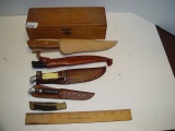 4 knives with sheaths 1 pocket knife and a dove tailed wooden box