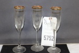 Three Long Stem, gold rimmed Champagne Flutes