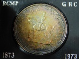 1973 CANADIAN SILVER DOLLAR IN HOLDER (TONING) BU