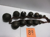 STRING OF 12 GRADUATED SLEIGH BELLS ON LEATHER STRAP