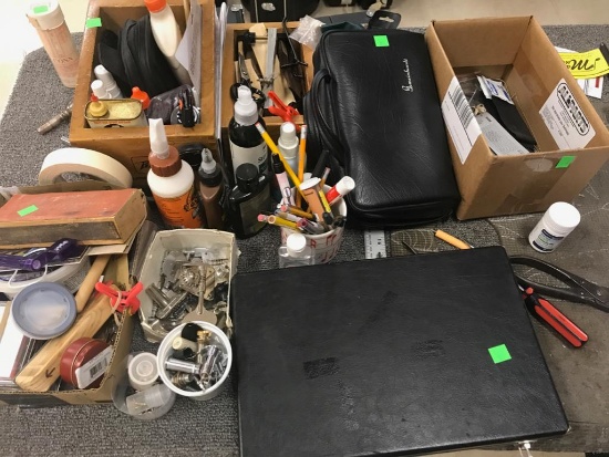 Workbench clean-off of various tools and instrument repair pieces and parts