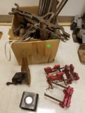 Miscellaneous small cast iron clamps and steel bars.