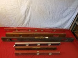 Collection of assorted wooden levels and one aluminum