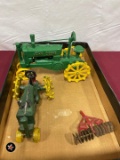 (2) John Deere cast iron toys and a smaller red disc