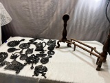 Pair of andirons and large assortment of trivets