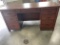 Solid wood desk; seven drawers.